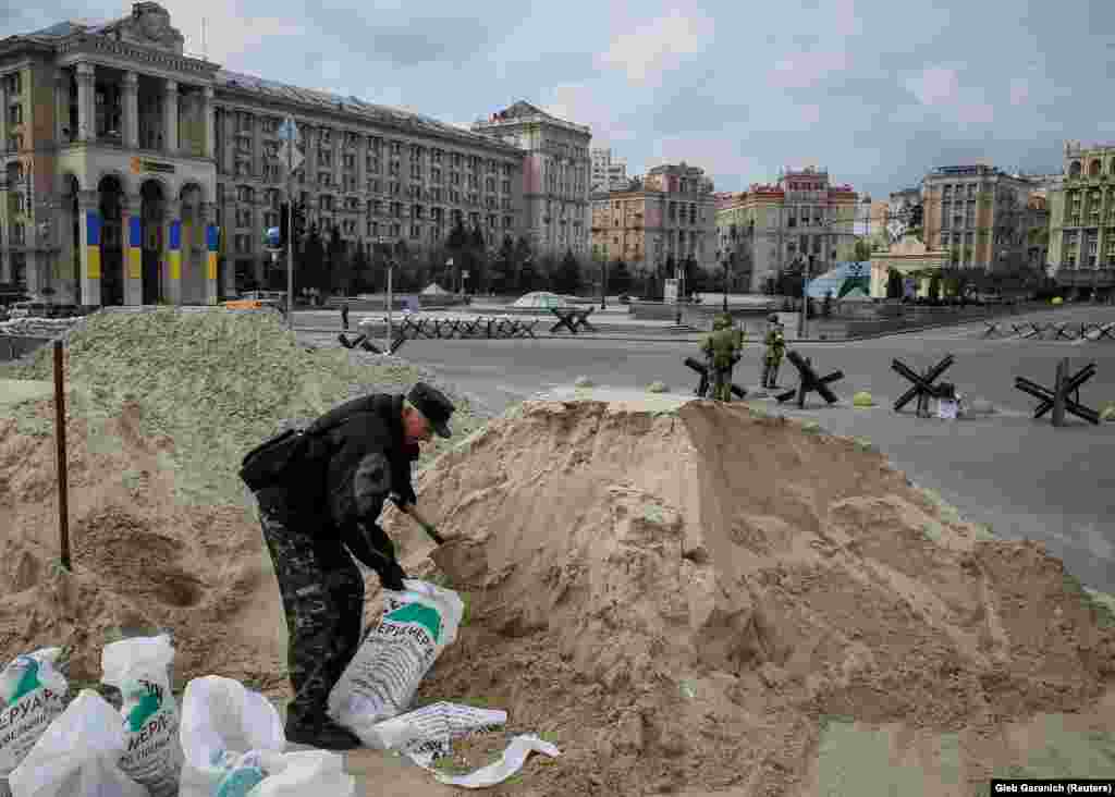 A man fills sacks with sand as part of preparations for the defense of Kyiv as the Ukrainian capital was surrounded by Russian forces in early March.