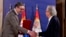 Austrian author Peter Handke, right, receives the Order of the Serbia from President of Serbia Aleksandar Vucic during the ceremony in Belgrade, May 9, 2021. 