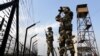 Indian Border Security Force soldiers patrol the fence alone the India-Pakistan border. (file photo)