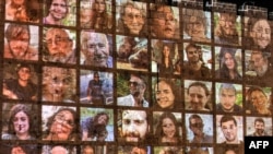 Fotografitë e disa prej pengjeve të marra nga Hamasi në Izrael, të vendosura në një mur në Jerusalem.