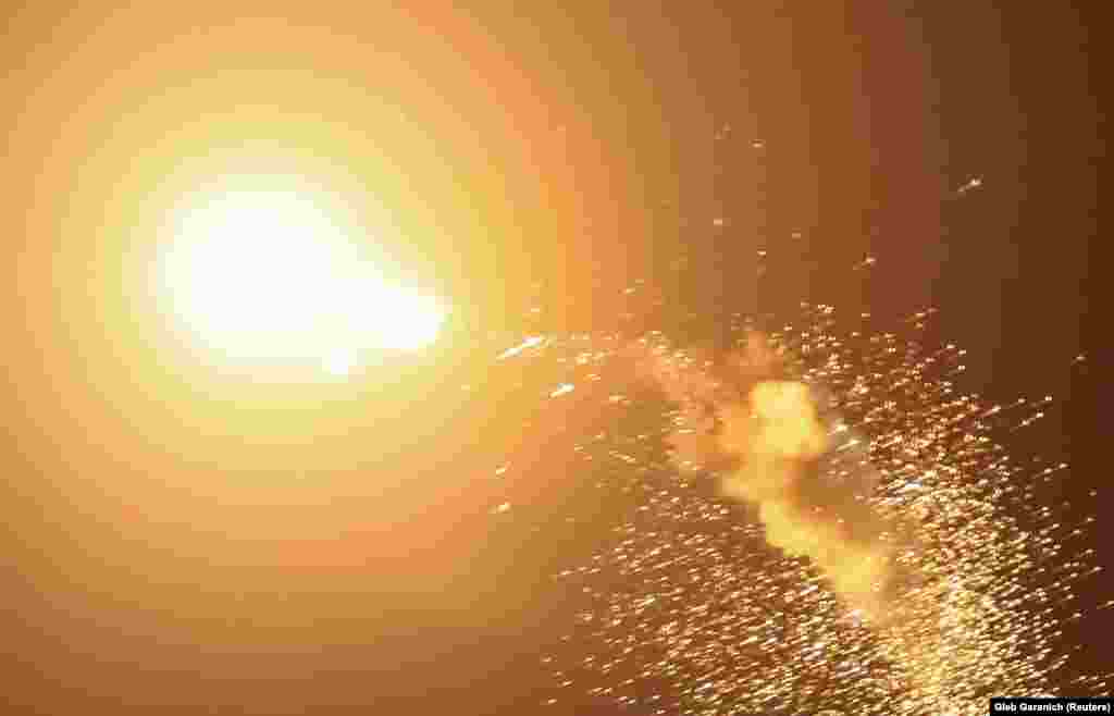 A drone explodes in the sky above Kyiv. Mayor Vitali Klitschko, writing on Telegram, said the body of one resident was recovered when emergency services put out a fire in the capital&#39;s historic Podil district.