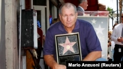 Ед О'Нийл позира със своята звезда на Алеята на славата в Холивуд.