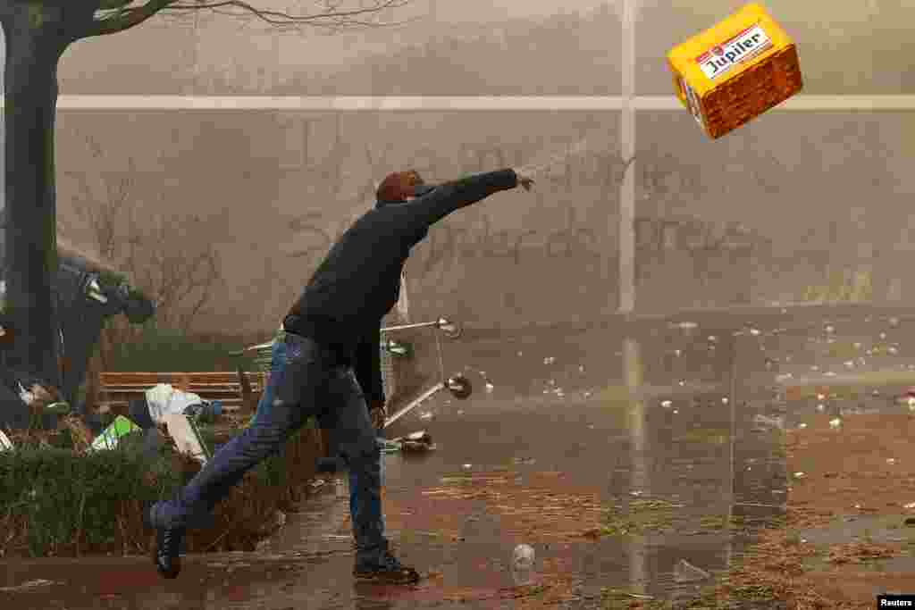 Një protestues hedh një arkë të zbrazët birrash Jupiler, gjatë një proteste të fermerëve në Bruksel.