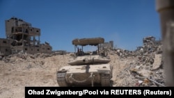Izraelski tenk pored uništenih zgrada tokom kopnene operacije u južnom Pojasu Gaze, usred sukoba Izraela i Hamasa, 3. jula 2024.