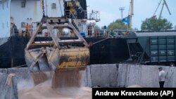 Radnici utovaruju žitarice na brod u luci u Izmajilu, Ukrajina.