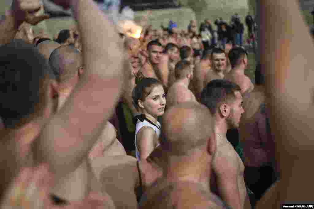 Sârbii din Kosovo se pregătesc să sară în apa rece a lacului Gazivoda, în apropiere de orașul Zubin Potok, la nord de Mitrovica, în căutarea crucii care va fi aruncată de un preot.&nbsp;(foto Armend Nimani/ AFP)