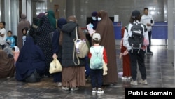 Kyrgyz women and children arrive in Bishkek from a Syrian refugee camp in August.