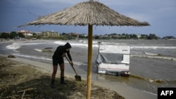 Жена разчиства на плажа на къмпинг Арапя след наводненията по Южното Черноморие. Силният дъжд, придошлите реши и прелелите язовири доведоха и до смъртта на четирима души. 8 септември беше обявен за ден на национален траур в памет на жертвите.