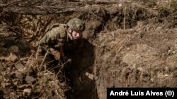 Un soldat exersează un asalt în tranșee, un tip de război care se află în centrul încercărilor ucrainene de a străpunge apărarea rusă.