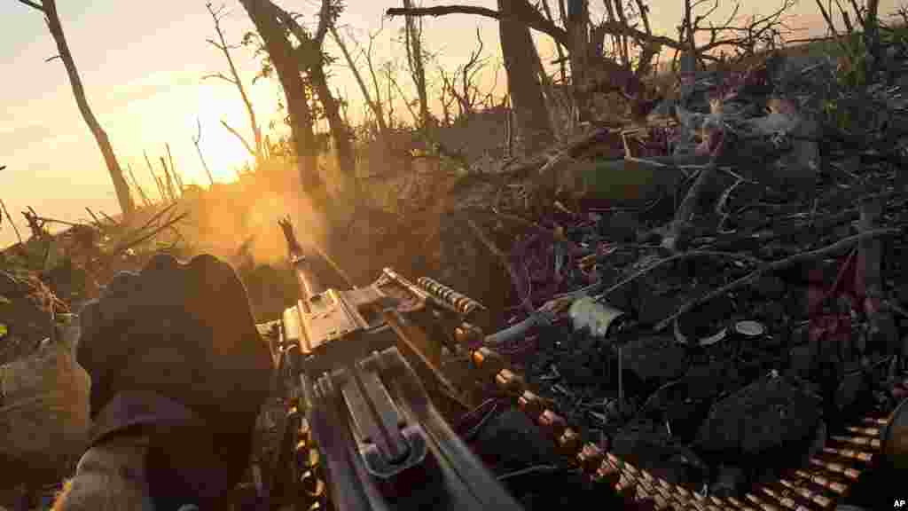 A member of Ukraine&#39;s 3rd Assault Brigade fires a machine gun toward Russian positions near&nbsp;Andriyivka on August 27 in this image captured from a video. The Associated Press had an&nbsp;intimate glimpse into the Ukrainian counteroffensive with the use of helmet cameras and drone video.