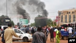 Qytetarët shikojnë tymin duke dalë nga ndërtesa e partisë së presidentit të rrëzuar nga pushteti në Niger.