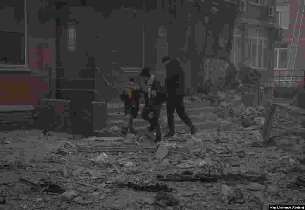 Residents evacuate buildings damaged during the attack in the Black Sea port city of Odesa. &nbsp;