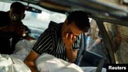 Палестинец плаче над тялото на свой близък, убит при атаката в лагер в Рафах, Ивицата Газа, 27 май 2024 г.