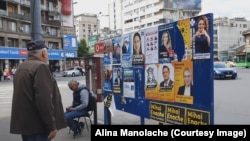 Un bărbat privește afișele electorale în Piața Romană din București. Duminică, pe 9 iunie, în România sunt alegeri locale și europarlamentare.