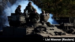 Ukrainian soldiers ride a BREM-1 evacuation tank near the frontline town of Vuhledar in the Donetsk region on March 6.