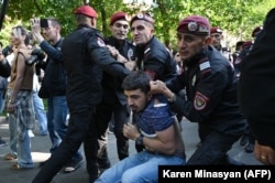 Poliția armeană reține un protestatar în timpul unui miting anti-guvernamental în Erevan, pe 27 mai.