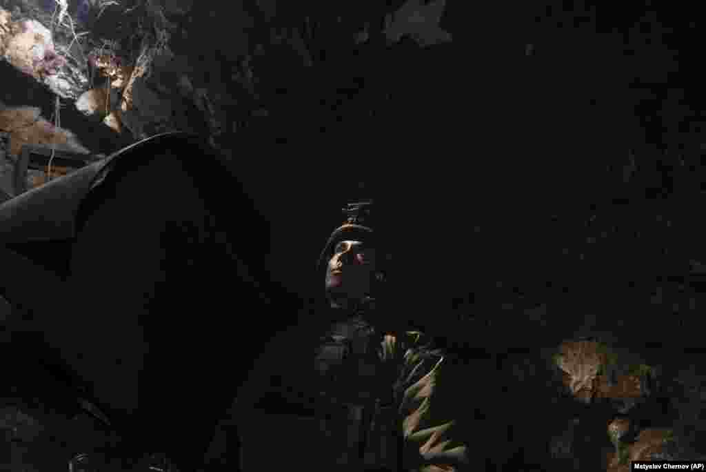 A Ukrainian soldier takes cover in a bunker at the front line in&nbsp;Andriyivka on September 16. The goal of the brigade has been the capture of Andriyivka. After more than three months of battle, they finally broke through the shelling and the drone-launched grenades, firing at the Russian forces who fled in front of them.