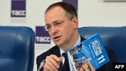 Kremlin aide Vladimir Medinsky presents a new schoolbook for high-school students on general world history and Russian history in Moscow on August 7.