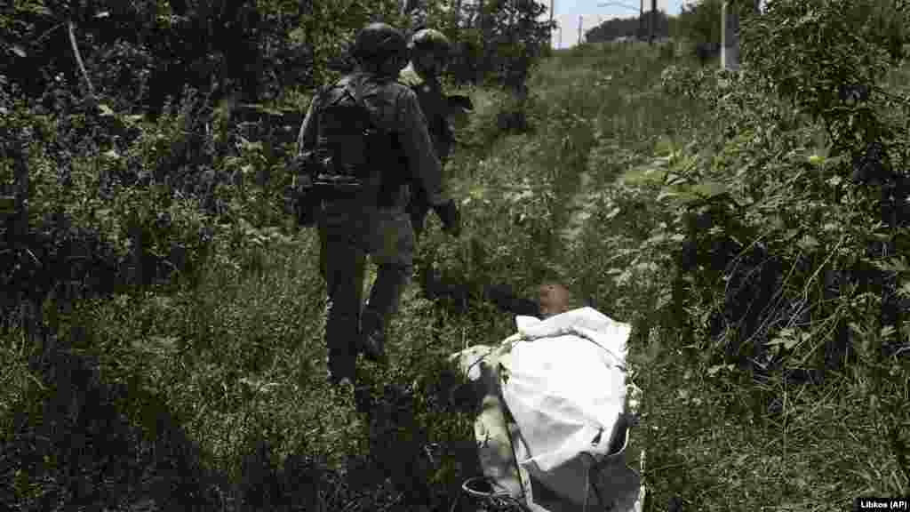 Soldați ucraineni merg pe linia frontului în apropiere de Bahmut. &nbsp;