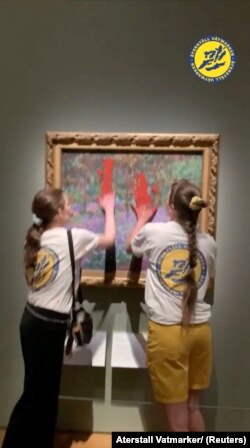 Klimatski aktivisti Aterstall Vatmarker (Obnovite močvare) razmazuju crvenu boju na zaštitnom staklu Monetove slike, izložene u Nacionalnom muzeju, u Stockholmu, Švedska, 14. juli 2023.