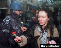 Studenti nude cveće policajcima tokom protesta u decembru 1996.