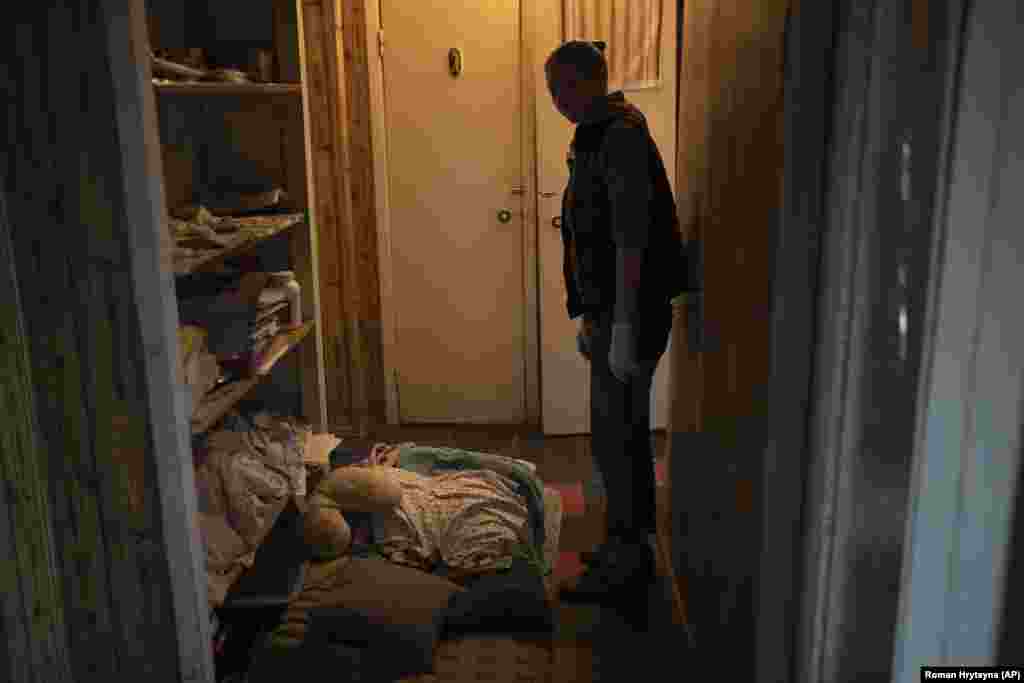 A woman in Kyiv shows the location where she sleeps in her apartment during Russian rocket attacks.