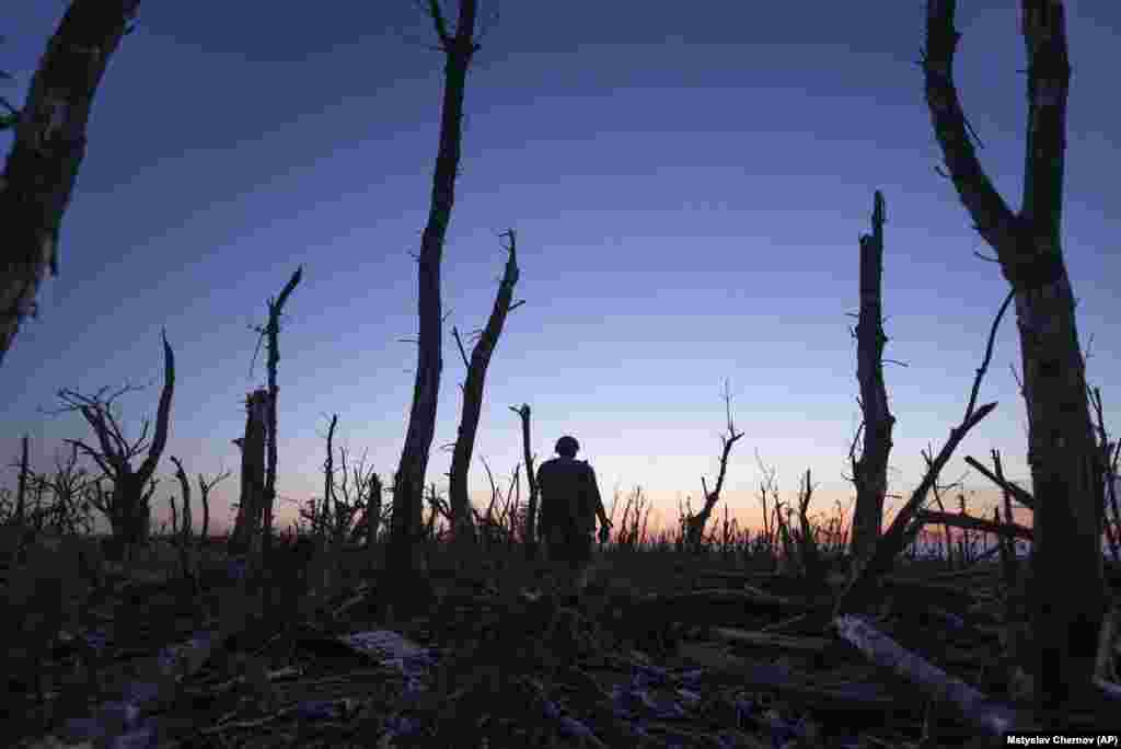 A Ukrainian soldier walks through the charred forest at the front line a few kilometers from&nbsp;Andriyivka. Ukrainian officials said this month&rsquo;s battle&rsquo;s for the road to Bakhmut may have taken as many as three Russian brigades out of combat. Neither side has released casualty figures.&nbsp;
