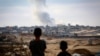Dy djem duke e shikuar tymin që ngrihet lart nga ndërtesat në Rafah, Gazë, gjatë sulmeve izraelite kundër Hamasit, 31 maj 2024.