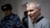 Aleksei Moskalyov is escorted from a courtroom in Yefremov in Russia's Tula region, some 300 kilometers south of Moscow, on March 27.