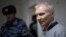 Aleksei Moskalyov is escorted from a courtroom in Yefremov in Russia's Tula region, some 300 kilometers south of Moscow, on March 27.