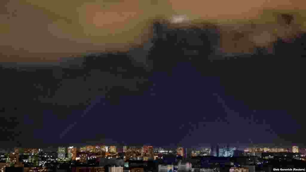 Ukrainian air defenses use a searchlight as they hunt for drones in the sky over Kyiv.