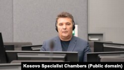 Paraqitja e parë e Haxhi Shalës para Dhomave së Specializuara të Kosovës në Hagë. 13 dhjetor 2023.