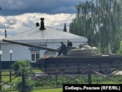 Children play on a war memorial in Yashkino.