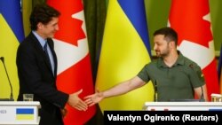 Ukrajinski predsednik Volodimir Zelenski (desno) i kanadski premijer Džastin Trudo rukuju se tokom zajedničke konferencije za novinare u Kijevu, 10. juna 2023. godine