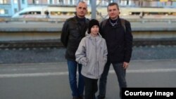 Yegor with Uncle Dima (left) and his father in 2019