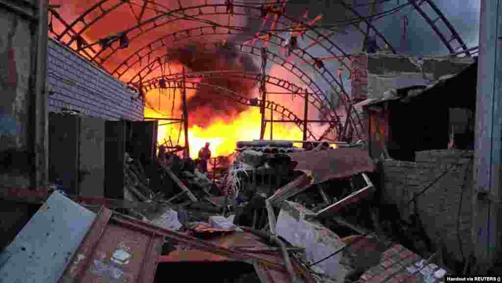 A firefighter battles a blaze at a storage facility hit by a Russian missile strike in Dnipro, eastern Ukraine. Authorities reported that a 31-year-old woman and her 2-year-old daughter were killed in the early morning strike. &nbsp; 