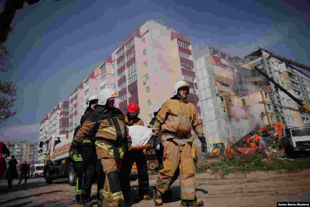 Rescuers remove the body of one of those killed in Uman in the early morning attack.&nbsp;The Ukrainian capital, Kyiv, was also rocked by explosions. Officials reported that air-defense units shot down 11 missiles and two drones.