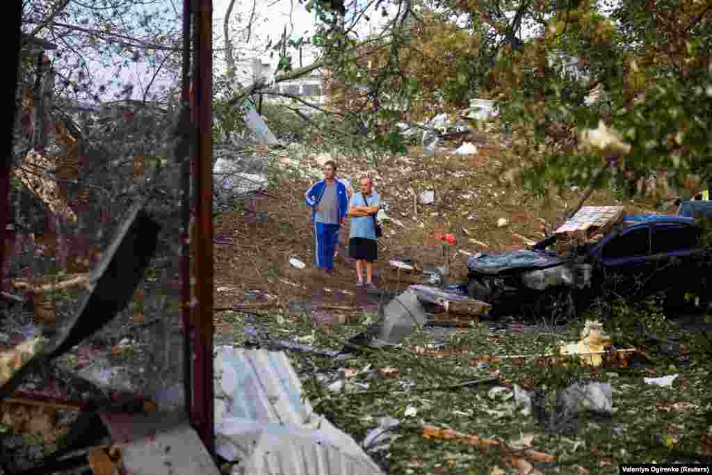 Residents in Kyiv survey the damage following the early morning missile attack.