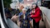 UKRAINE -- People help Liudmila, 85, to sit into a bus after their evacuation from Vovchansk, Ukraine, Sunday, May 12, 2024.