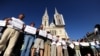 Aktivisti i aktivistkinje u Hrvatskoj ispred Zagrebačke katedrale nose imena žrtava u Ahmićima u znak protesta protiv dočeka Darija Kordića u zračnoj luci u Zagrebu, jun 2014. 
