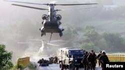 Trupat britanike, duke u ulur me helikopterë, bashkohen me forcat e tjera britanike për të siguruar një urë në jug të Kaçanikut, Kosovë, më 12 qershor 1999.