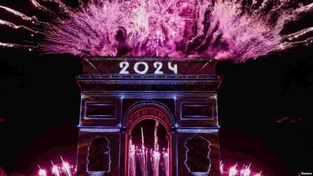 Tűzijáték világítja be az eget a Diadalív felett Párizsban 2024. január 1-jén