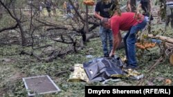 A body is covered in the courtyard of an apartment building in Mykolayiv on July 19 after a deadly Russian missile attack.