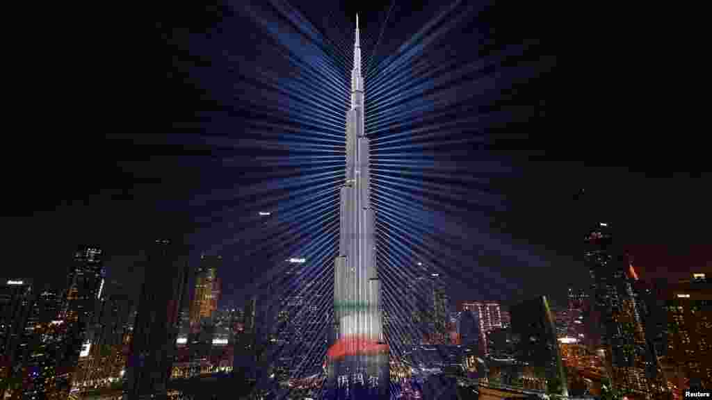 Az Egyesült Arab Emírségek zászlajának színei a világ legmagasabb épületére, a Burdzs Kalifára vetülnek a szilveszteri ünnepségek alatt Dubajban 2023. december 31-én