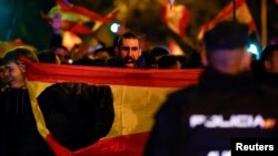 Демонстрант държи испанско знаме с изрязан герб по време на протест близо до централата на социалистическата партия в Мадрид, Испания, 8 ноември 2023 г.