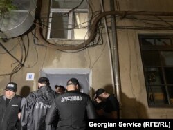 უჩა აბაშიძის კორპუსის სადარბაზოში პოლიცია არ უშვებს ოჯახის წევრებს და ჟურნალისტებს - ადგილზე მყოფი სამართალდამცველები ამბობენ, რომ "მიმდინარეობს საპოლიციო ღონისძიება".