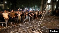 Протестиращи срещу спорен проруски закон в Грузия атакуват загражденията на парламента в Тбилиси, 1 май 2024