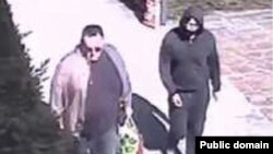 A still image taken from surveillance video allegedly showing Artyom Uss (right) escaping house arrest in Milan, Italy, on March 22, 2023. 