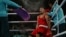 A Kazakh boxer catches his breath between rounds at a match during the Paris Olympics.