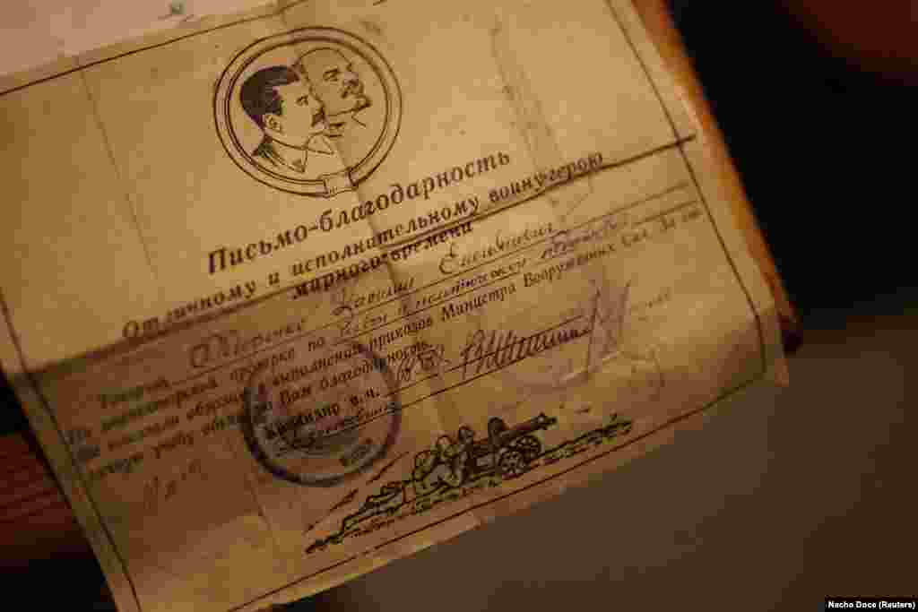 As her memory fades, Nikolaevna occupies her time perusing dog-eared magazines, rearranging her husband&#39;s medals, and reading commendations like this one, which was written to her husband to express appreciation for his participation in the Soviet Union&#39;s victory in its brief war with Japan at the end of World War II. These are a handful of the priceless keepsakes from her previous life before being forced to move underground.